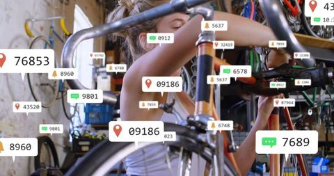 Female Technician Repairing Bicycle in High-Tech Workshop