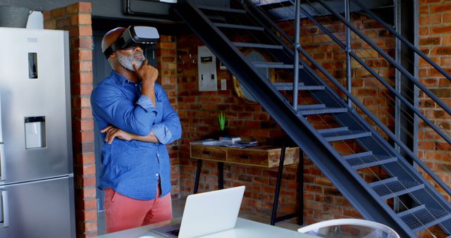 Man Wearing VR Headset eExploring Virtual Reality in Modern Loft - Download Free Stock Images Pikwizard.com