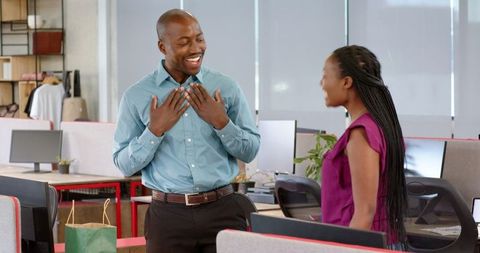 Office colleagues celebrating birthday with joyful exchange