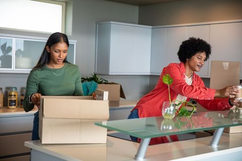 Couple unpacking in modern kitchen together