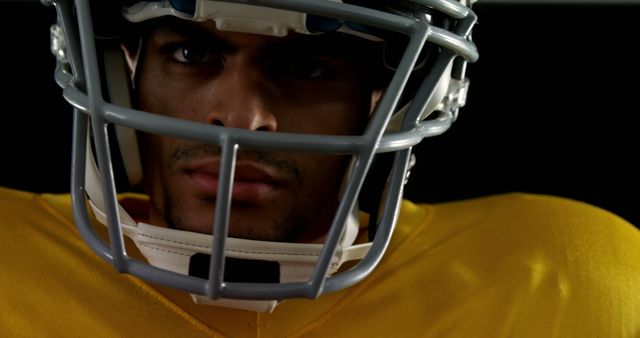 Determined American Football Player in Helmet and Yellow Jersey - Download Free Stock Images Pikwizard.com