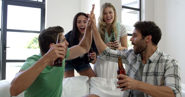 Group of Friends Enjoying Beers and High-Fiving Indoors - Download Free Stock Images Pikwizard.com