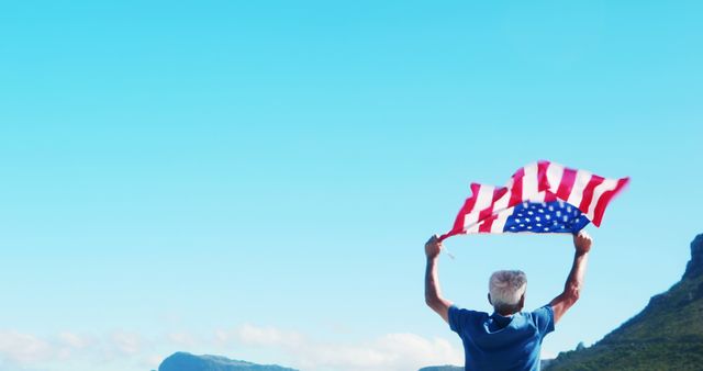 Senior Man Holding US Flag with Clear Blue Sky - Download Free Stock Images Pikwizard.com