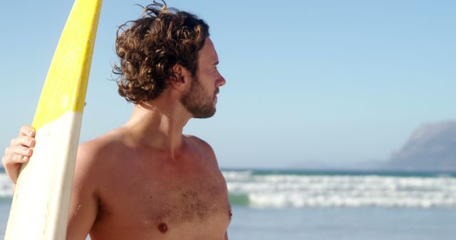 Surfer Standing on Beach Holding Surfboard by Ocean - Download Free Stock Images Pikwizard.com