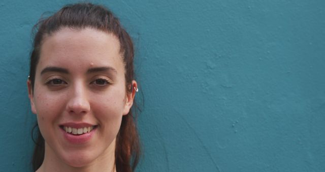 Smiling Woman With Brown Hair Against Blue Wall - Download Free Stock Images Pikwizard.com