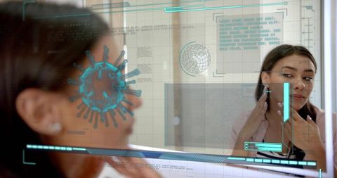 Female clinician examining jaw using augmented reality mirror with viral hologram and hud
