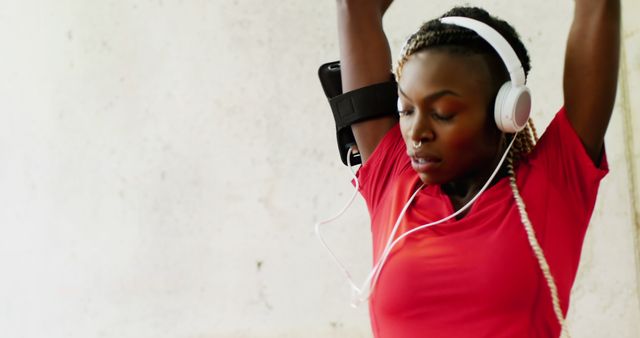 Focused Woman Wearing Headphones in Gym, Preparing for Workout - Download Free Stock Images Pikwizard.com