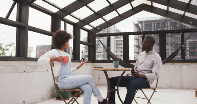 Relaxed Between Colleagues Chatting on Rooftop Terrace with Coffee - Download Free Stock Images Pikwizard.com