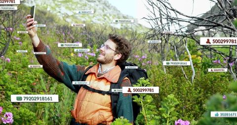 Hiker taking selfie surrounded by nature with digital enhancements