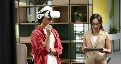 Colleagues Exploring Virtual Reality Technology in Modern Office