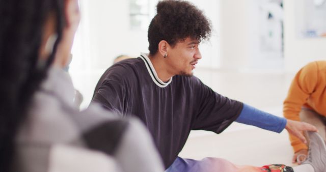 Young Man Engaging in Group Discussion - Download Free Stock Images Pikwizard.com