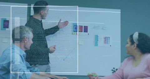 Creative team collaborating on UX mockups in conference room with digital UI overlay