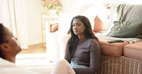 Diverse Friends Bonding Over Casual Conversation in Cozy Living Room