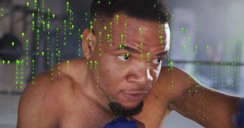 Intense shirtless boxer throwing right punch with blue glove and green code overlay in gym