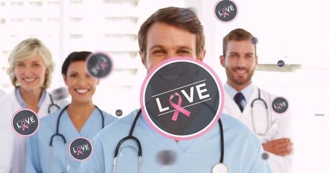 Smiling Medical Team Embracing Breast Cancer Awareness