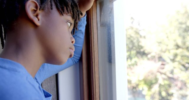 Pensive Black Boy Looking Through Window Thoughtfully - Download Free Stock Images Pikwizard.com