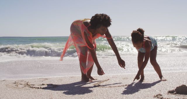 Mother and Daughter Enjoying Day at Beach Writing in Sand - Download Free Stock Images Pikwizard.com