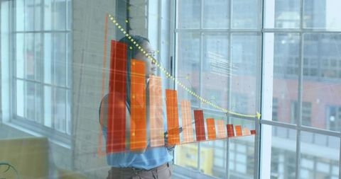 Businesswoman analyzing interactive bar chart with downward trend projected on loft window