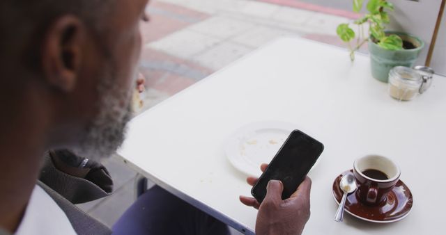 Man Using Smartphone at Outdoor Cafe Table with Coffee - Download Free Stock Images Pikwizard.com