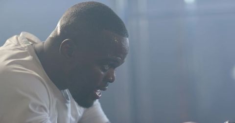 African Man Catching Breath After Intense Gym Workout Showing Focus and Sweat