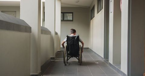 Child in Wheelchair Navigating Educational Corridor for Accessibly-Focused Motivation