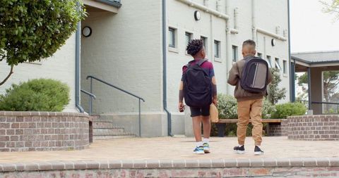 Young Students Walking to School Building