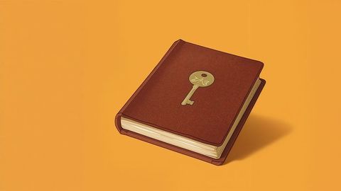 Brown leather book with metallic key emblem on orange