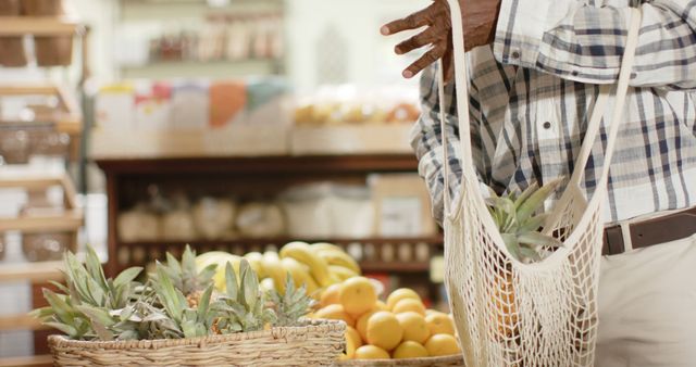 Man Grocery Shopping with Reusable Mesh Bag in Market - Download Free Stock Images Pikwizard.com