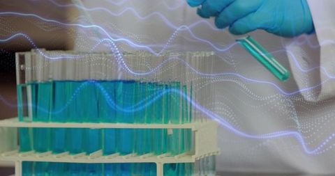 Laboratory technician handling turquoise test tube with digital data overlay, biotech research