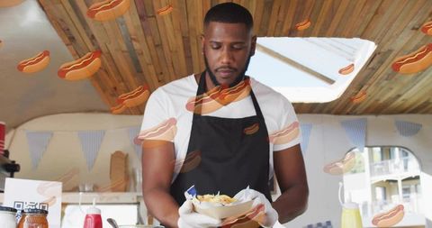Street food vendor serving loaded fries in paper bowl at bustling market stall with condiments