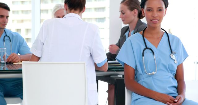 Smiling Nurse with Medical Team in Conference Room - Download Free Stock Images Pikwizard.com