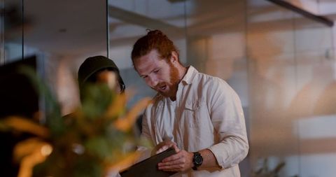 Focused Team Collaborating on Digital Project in Modern Office