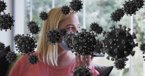 Woman In Mask Using Smartphone with 3D Virus Particles Overlay