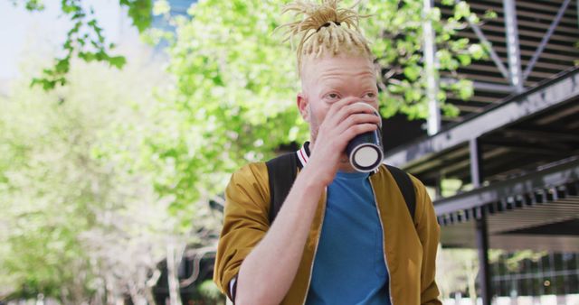 Stylish Young Man Drinking Coffee Outdoors in Urban Setting - Download Free Stock Images Pikwizard.com