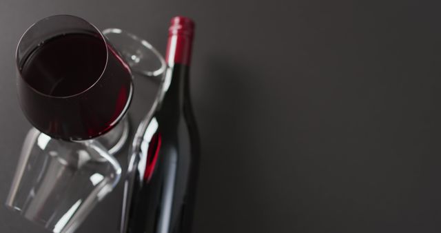 Red wine glass and bottle on dark background - Download Free Stock Images Pikwizard.com