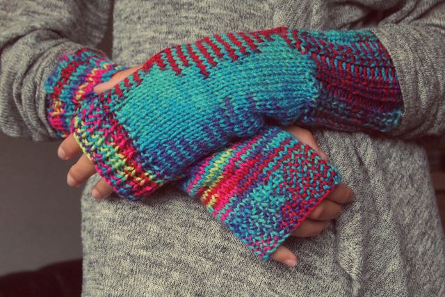 Colorful Knitted Fingerless Gloves On Gray Sweater - Download Free Stock Photos Pikwizard.com