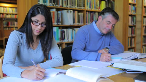 Mature Students Studying in Library with Focused Expression