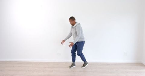 Young Man Perfecting Dance Moves in Bright Indoor Space - Download Free Stock Images Pikwizard.com