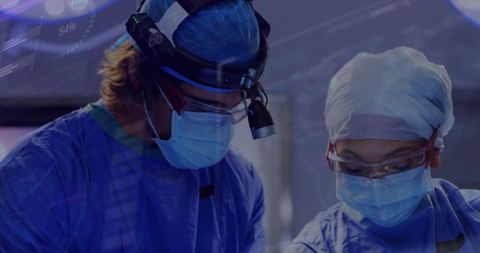 Surgeons in Blue Gowns Performing Procedure in Modern Operating Room