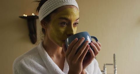 Woman Enjoying Facial Mask and Coffee in Relaxing Setting
