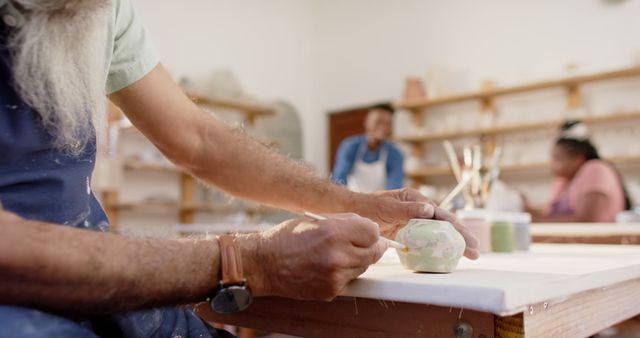 Senior Artisan Painting Ceramic in Pottery Workshop - Download Free Stock Images Pikwizard.com