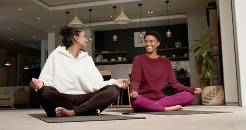 Women Practicing Yoga Meditation in Living Room for Mental Clarity