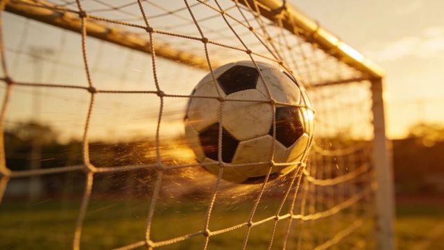 Soccer ball striking goal net at sunset with motion blur and golden hour dust trail action