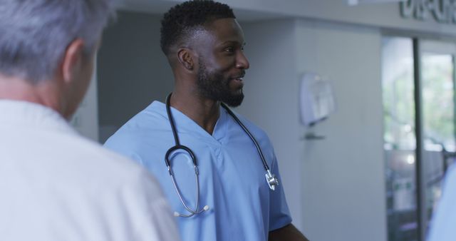 Smiling Nurse in Scrubs Talking with Colleague in Hospital - Download Free Stock Images Pikwizard.com