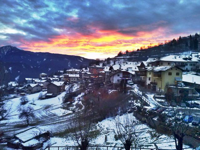 Sunset Over Snow-covered Mountain Village in Winter - Download Free Stock Photos Pikwizard.com