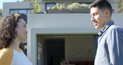 Joyful Couple Conversing in Sunny Modern Suburban Patio Setting
