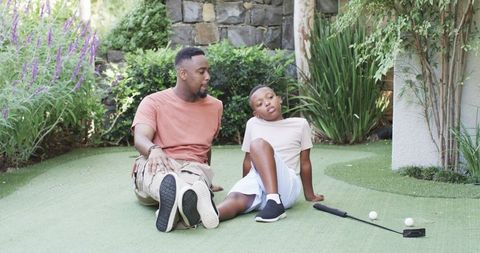 Father and Son Enjoying Outdoor Golf Practice at Home