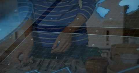 Pottery and tech fusion: woman shaping clay with hand tools under digital grid overlay