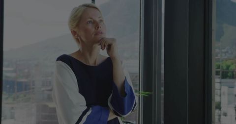 Pensive Woman Overlooking City from Highrise with Panoramic Views