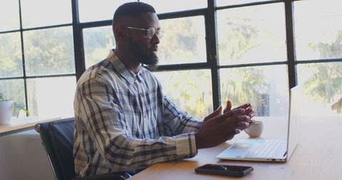 Businessman in Plaid Shirt Discussing Ideas on Video Call